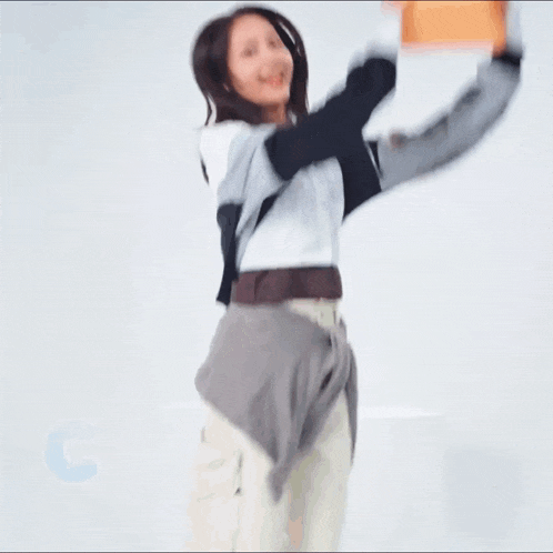 a woman holds up a block with the letter c on it