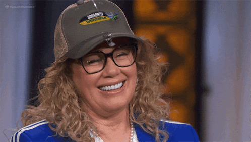 a woman wearing glasses and a baseball cap that says diversity