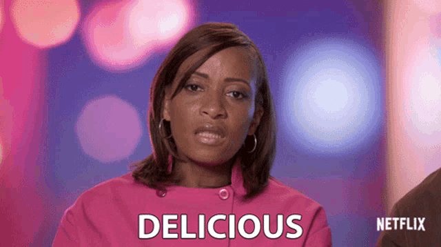 a woman in a pink jacket says delicious