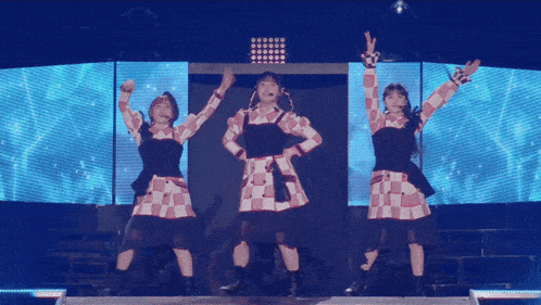 a girl with a microphone on her head is dancing on a stage