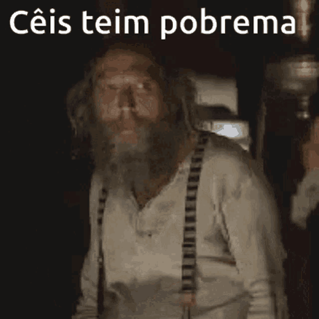 a man with a beard and suspenders says " ceis teim pobrema " in white letters