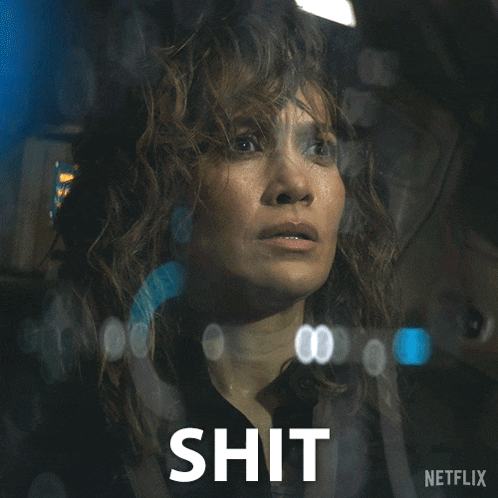 a woman behind a glass with the word shit written below her
