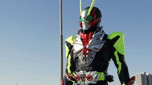 a man in a superhero costume is standing in front of a street light
