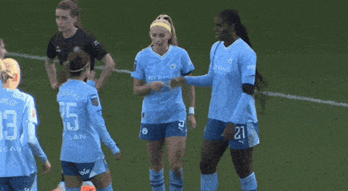 a group of female soccer players wearing light blue jerseys with the number 27 on the back