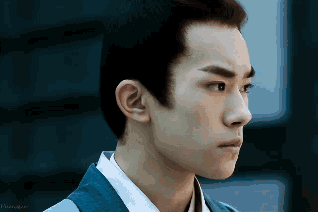 a close up of a man 's face with the name huanyao on the bottom left
