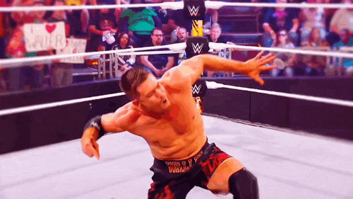 a wrestler in a ring with a sign that says i love you