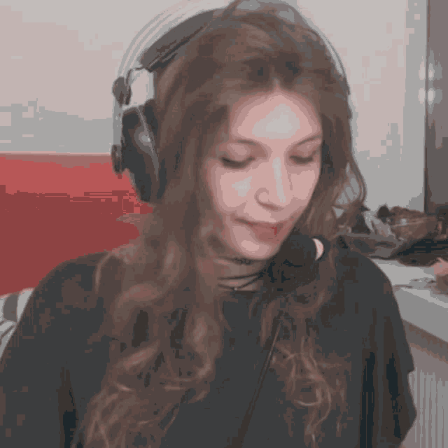 a woman wearing headphones and a microphone looks serious