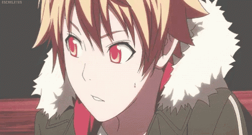 a boy with blonde hair and red eyes is wearing a furry jacket .