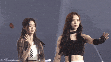 two women are standing next to each other and one of them has the number 16 on her chest