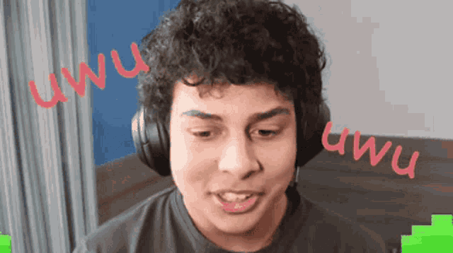 a young man wearing headphones with the word uwu written on the bottom