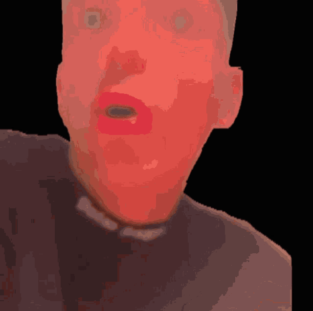 a close up of a man 's face with red lips and a black background
