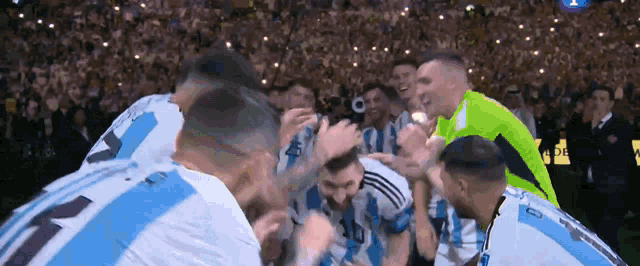 a group of soccer players are huddled together and one of them has the number 11 on his shirt