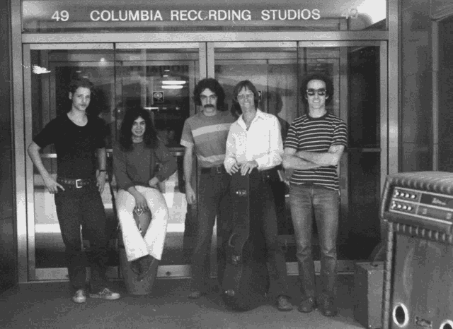 a group of men are posing for a photo in front of the columbia recording studios
