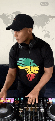 a man in a black shirt with a lion on it playing music