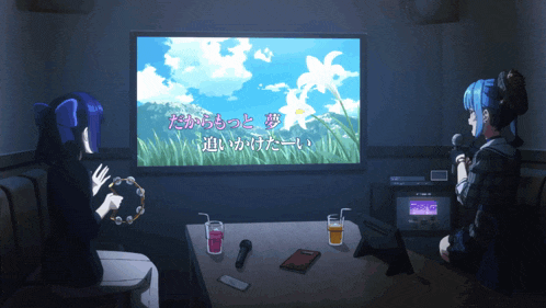 two girls singing in front of a screen that says ' a ' on it