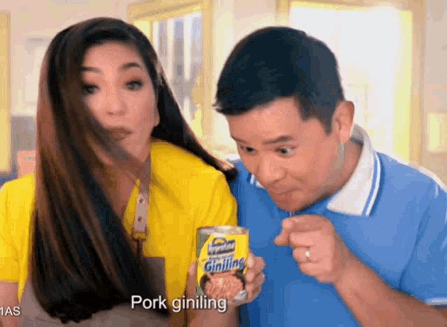 a man and woman are eating pork giniling
