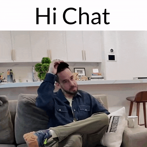 a man sitting on a couch with his legs crossed and the words hi chat on the bottom