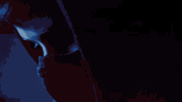 a close up of a person 's face with a blue background