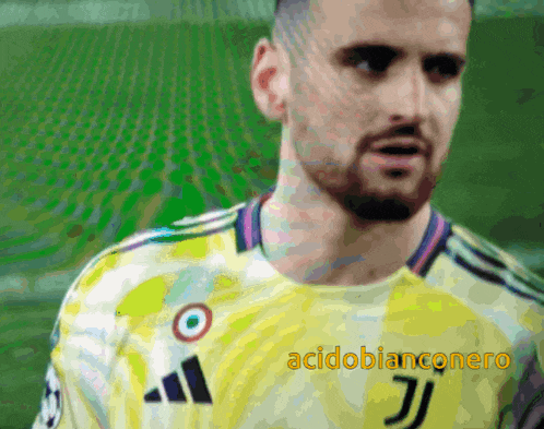 a man with a beard is wearing a yellow jersey with the letter j on it