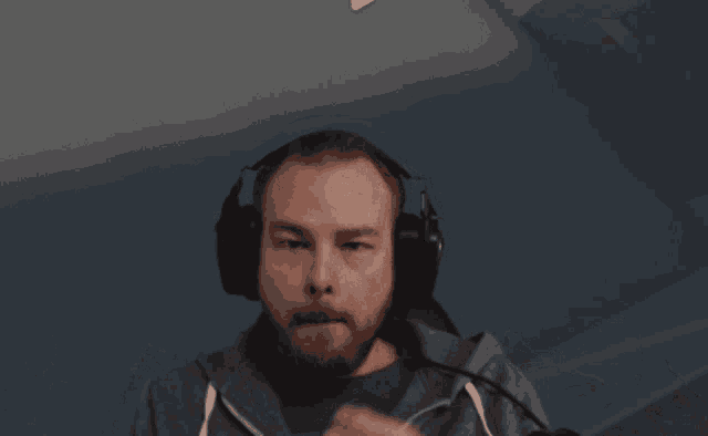 a man with a beard is wearing headphones and a hoodie that says army on it