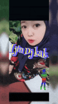 a girl in a blue hijab is shown with the words jin djkak written above her