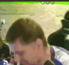 a blurry picture of a man 's face with a green background behind him
