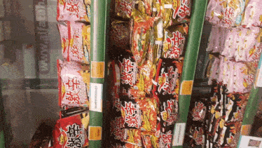 several bags of ramen noodles are lined up in a store