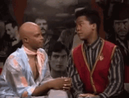 two men are shaking hands in front of a crowd