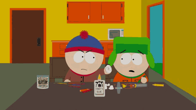 stan and kyle from south park are sitting at a table with glue and colored pencils