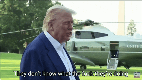 donald trump is standing in front of a united states helicopter