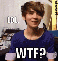 a young man in a blue shirt is making a funny face and says lol wtf