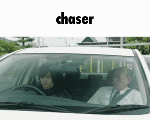 a man and a woman are driving a car and the word chaser is above them