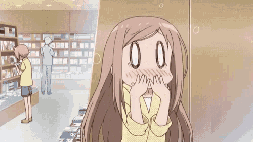 a girl covering her face with her hands in a store