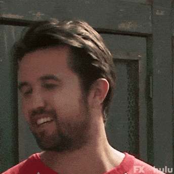 a man with a beard is wearing a red and white shirt that says hulu on the bottom
