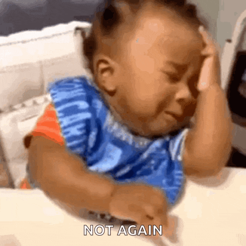 a baby is crying while sitting at a table and the words not again are on the bottom