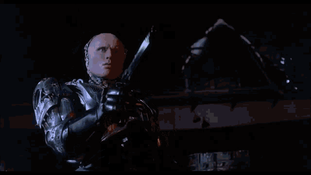 a man in a robot suit is holding a woman