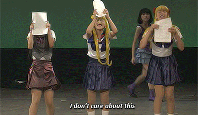 a group of girls are standing on a stage and one of them says i don t care about this