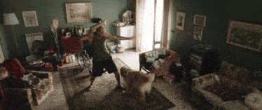 a man in a wheelchair is dancing with his dog