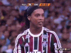 a soccer player stands in front of a scoreboard that says flu 0 gre