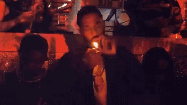 a man is holding a lighter in front of his face