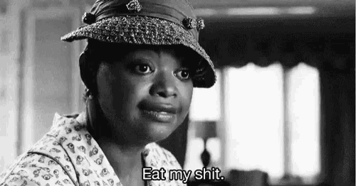 a black and white photo of a woman wearing a hat and saying `` eat my shit '' .