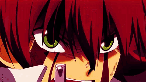 a close up of a person 's face with green eyes