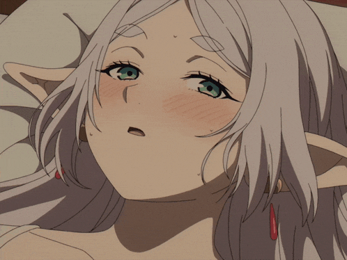 a girl with white hair and green eyes is laying down