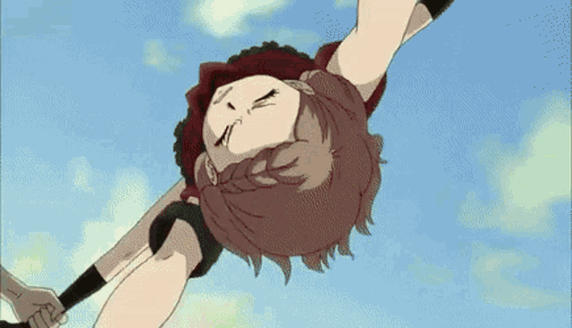 a girl is doing a handstand in the air with her eyes closed