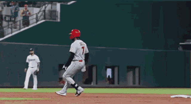a baseball player with the number 7 on his jersey is standing on the base