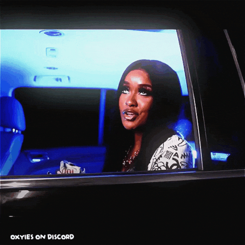 a picture of a woman in a car with the words " oxyies on discord " at the bottom
