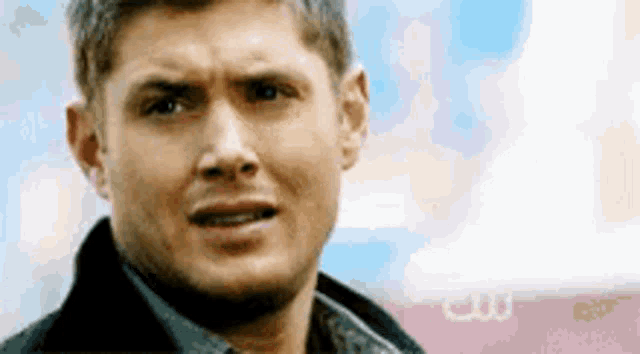 a close up of a man 's face with a surprised look on it .