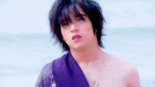 a young man with a purple scarf around his neck
