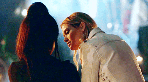 a couple of women are standing next to each other and hugging each other .