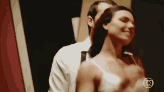 a man and a woman are dancing in a room .